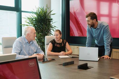 Staff at a desk talking